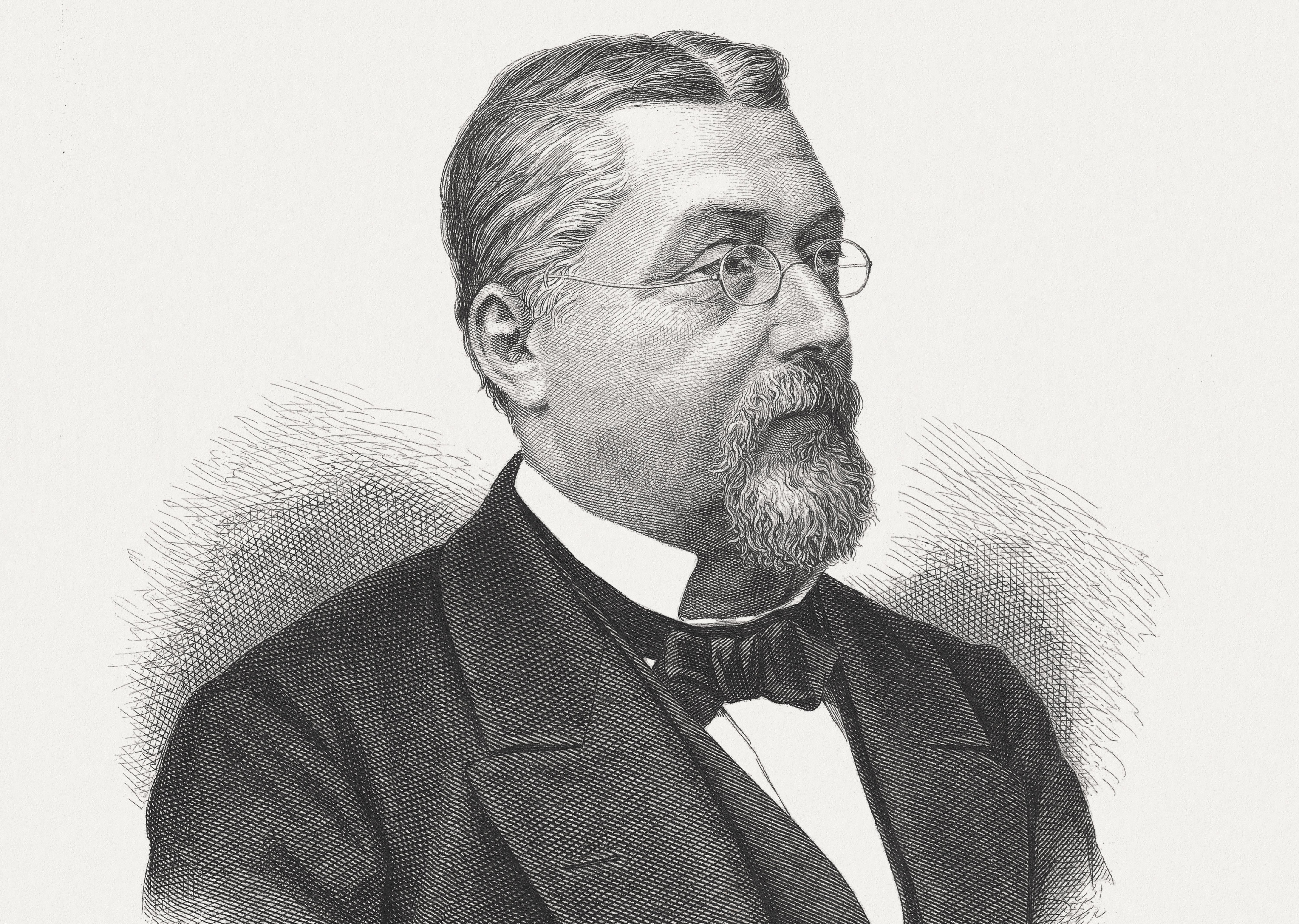 Ein Schwarz-Weiß-Porträt von Viktor von Scheffel im Anzug und mit Brille.